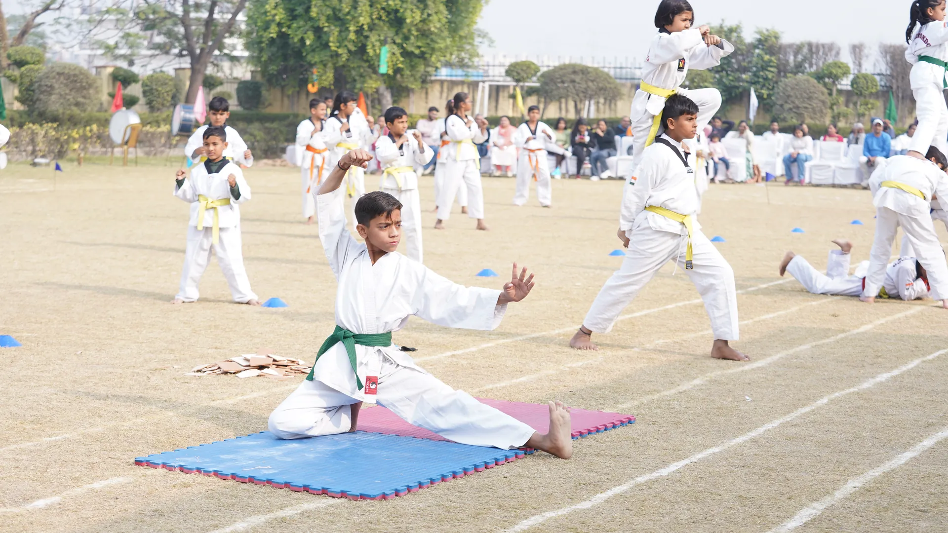 Students performing taekwondo on the school ground